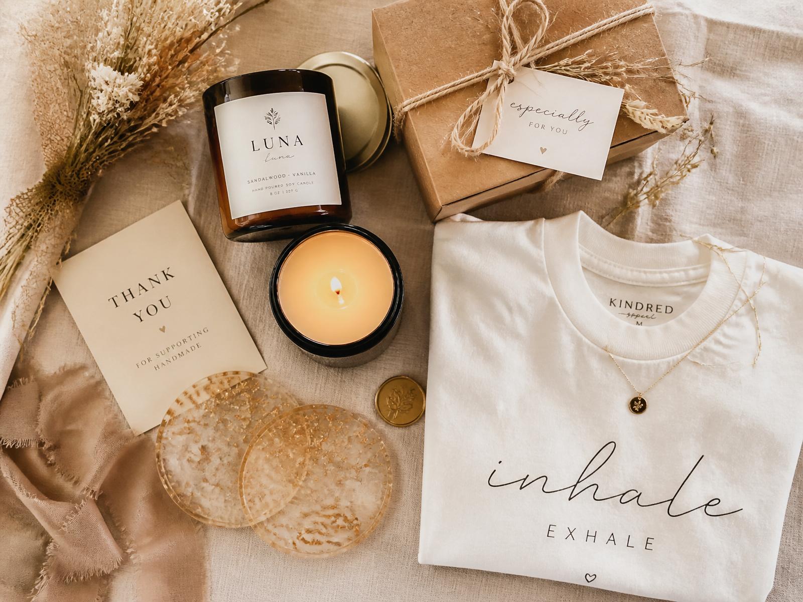Curated flat-lay of handcrafted candles, resin coasters, custom apparel and gift boxes